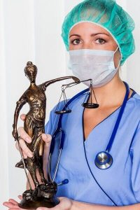 A nurse holding the scales of justice to symbolize a medical malpractice case in Florida hospital.