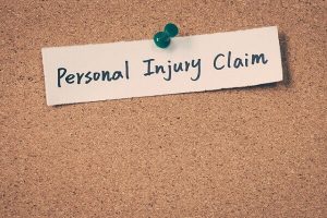 A note showing personal injury claim pinned in a board.